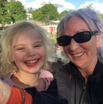 Leonie smiling with a child during a family support outing.