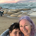 Leonie smiling with a client during a relaxed beach outing.