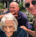 Leonie with an older female client and a family member during an outdoor outing.